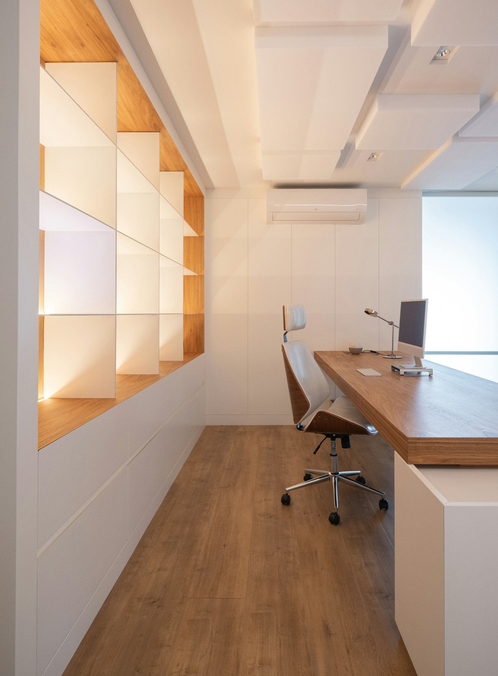 Built-in home office with wooden desk and integrated shelving