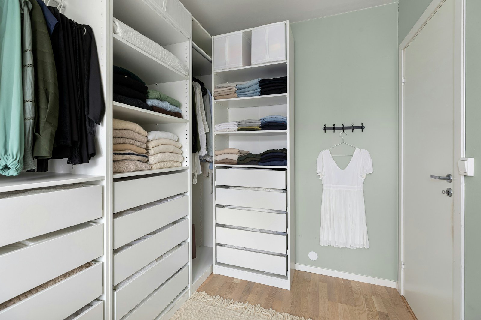White reach-in closet system with drawers, shelves and hanging space