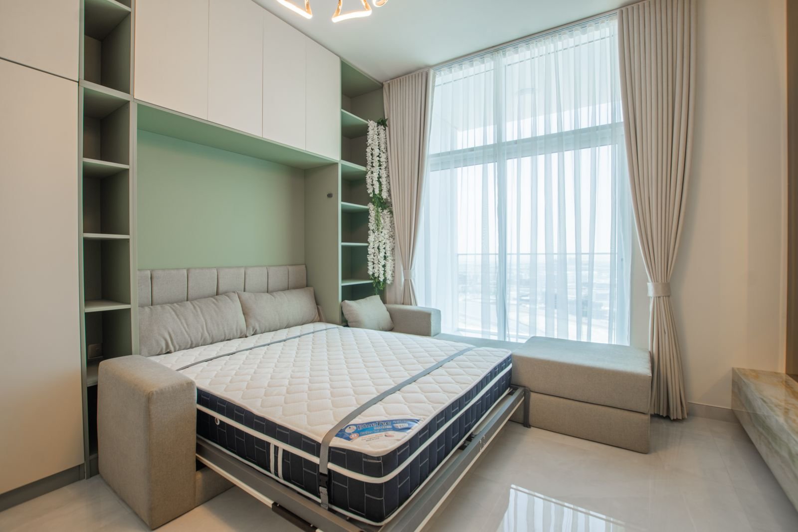 Murphy wall bed with side cabinets in a bright bedroom
